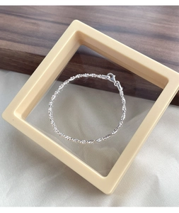 Macro shot of S925 sterling silver beaded bracelet with shimmering texture and lobster clasp