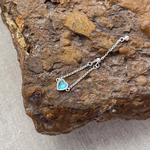 S925 silver adjustable chain ring with heart-shaped moonstone on natural stone background