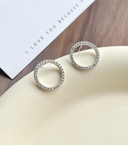 Macro detail of S925 sterling silver circle earrings with pave set zircon crystals