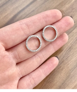 Macro shot of S925 sterling silver hoop earrings with pave cubic zirconia setting
