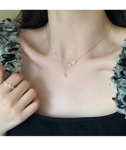 Close-up of S925 silver tulip necklace with freshwater pearl on woman's neck