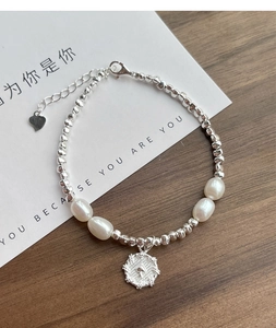 Dettaglio del bracciale in argento S925 con perle, ciondolo a cuore e catena regolabile