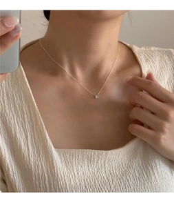 Detailed close-up of a gold S925 silver necklace with a square cubic zirconia pendant