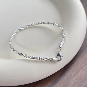 Sparkling S925 sterling silver twisted bead chain bracelet for women in a ceramic dish