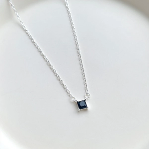 Minimalist S925 silver necklace featuring a square black zircon pendant in four-prong setting