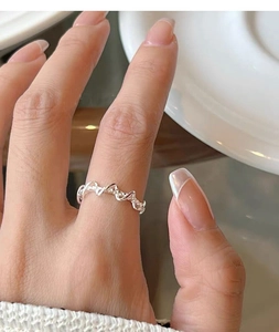 Close-up of S925 sterling silver woven ring on finger with sparkling zircon details