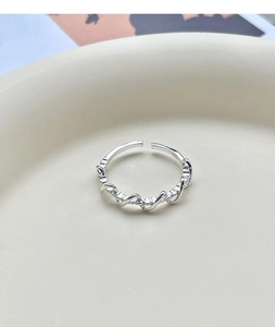 Close-up of S925 sterling silver twisted braided ring with shimmering pavé set zircons