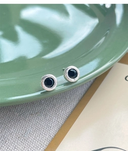 Close-up of S925 sterling silver studs with black agate and twisted rope border detail
