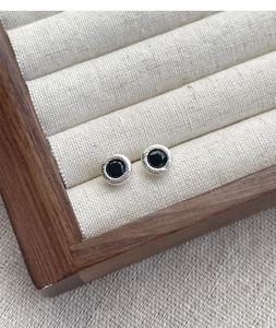 Macro shot of S925 sterling silver studs featuring black agate and rope texture edges