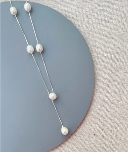 Detail view of S925 silver necklace featuring six asymmetrical freshwater pearls on a fine chain