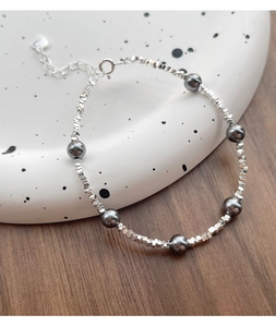 Detail of silver beaded bracelet with dark grey pearls and adjustable lobster clasp