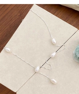 Detail view of five irregular freshwater pearls on a minimalist S925 silver chain