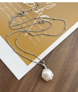Detail of S925 silver necklace with white irregular freshwater pearl and bead chain