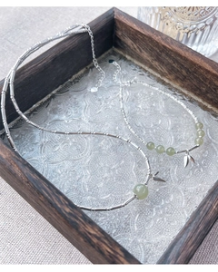 Detailed view of bamboo style silver necklace and bracelet set with green jade beads