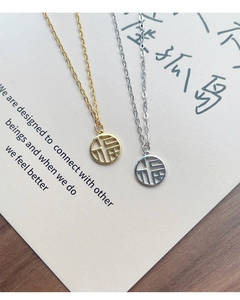 Detailed close-up of S925 silver Fu pendant necklaces in gold and silver finishes