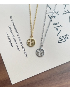 Close-up of gold and silver S925 sterling silver Fu character pendant necklaces