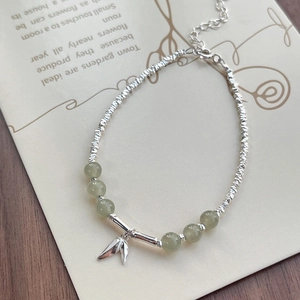 Elegant S925 silver beaded bracelet with Hetian jade and leaf pendant on wooden desk