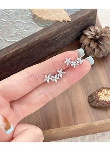 Detailed macro view of S925 silver triple flower stud earrings with marquise-cut zircon stones