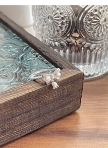 Detail view of S925 sterling silver bow ring with lily of the valley flower charm
