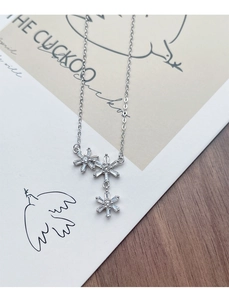 Macro shot of S925 silver snowflake necklace pendant with bright cubic zirconia stones