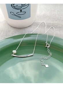 Detail of S925 silver necklace with Freedom engraving and a single freshwater pearl