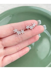 Close-up of S925 sterling silver flower stud earrings with marquise-cut cubic zirconia gems