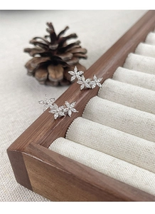 Macro shot of S925 sterling silver flower earrings with marquise-cut sparkling zircons