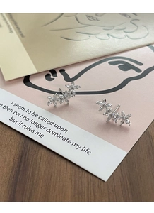 Macro shot of S925 silver flower stud earrings with marquise-cut sparkling zirconia stones