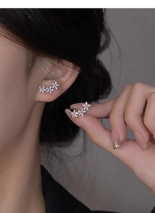 Detail of S925 sterling silver flower stud earrings with marquise cut cubic zirconia