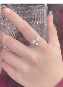 Detail of S925 sterling silver bow ring with lily of the valley bell and twisted band