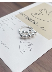 Detailed close-up of S925 sterling silver ring featuring dangling polished spheres design