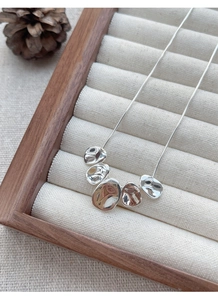 Detail of S925 silver snake chain necklace with five irregular liquid metal style beads