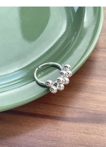 Detail of S925 sterling silver beaded ring with mirror finish on green ceramic