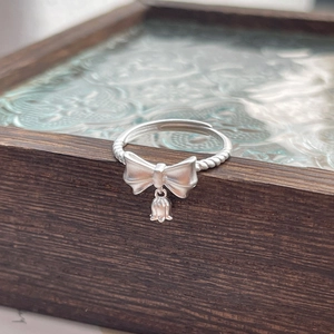Elegant S925 sterling silver bow and lily of the valley ring with adjustable twisted band