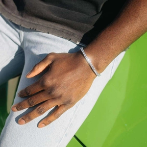 Détail d'un bracelet tennis en argent orné de zircons ronds brillants porté au poignet