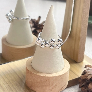 Minimalist S925 sterling silver grape cluster bead ring displayed on a jewelry stand