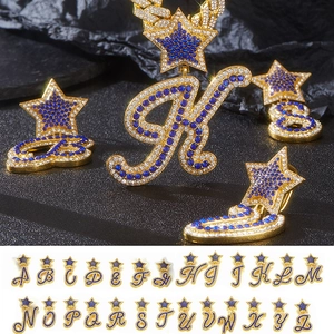Macro detail of iced-out A-Z alphabet pendants with blue crystals and star bale