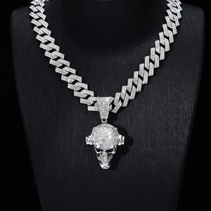 Detailed macro view of hip hop Cuban chain with silver plated iced out skull pendant