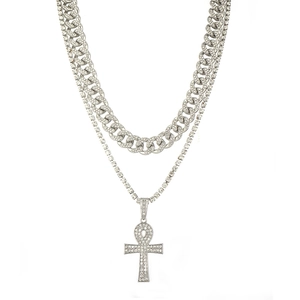Macro detail of iced-out punk Cuban link chain with Ankh cross pendant set