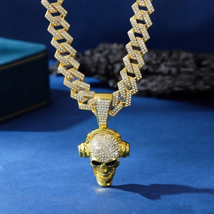Close-up of hip-hop skull pendant with headphones and iced-out gold Cuban chain