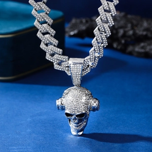 Detailed view of silver skull pendant with headphones and iced-out Cuban link chain