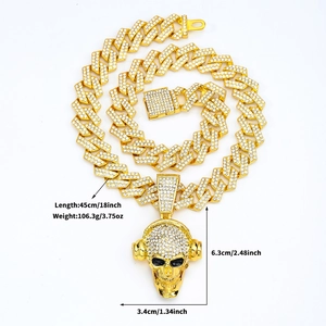Close-up of gold-plated skull pendant necklace with sparkling rhinestones and size details