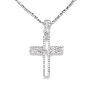 Macro view of silver cross pendant necklace with Jesus lettering and micro-pave crystals