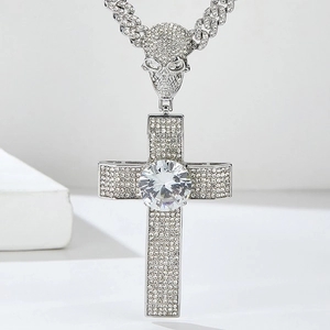 Close-up of hip-hop cross pendant with skull connector and sparkling iced out crystals