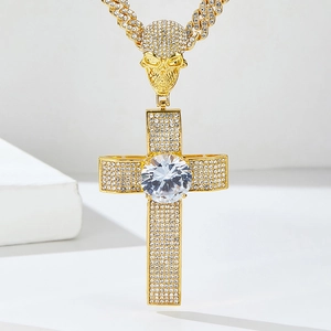 Macro detail of a gold hip hop cross pendant with skull bail and round cut diamonds