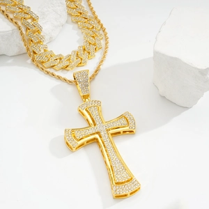 Detailed close-up of a hip hop gold cross pendant with cubic zirconia and rope chain
