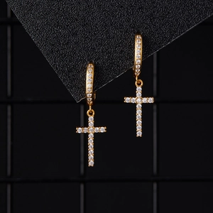 Detail von goldenen Kreuz-Ohrringen mit weißem Zirkonia-Mikropavé-Besatz