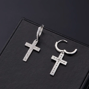 Detailed view of silver cross earrings with micro-pave white zircon on black display box