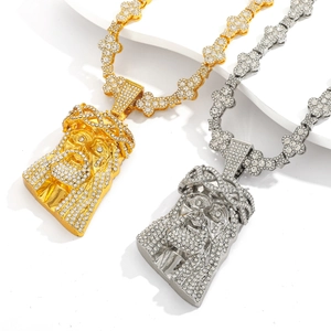 Gros plan de pendentifs Jésus hip hop dorés et argentés avec des cristaux brillants sertis
