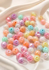 Macro shot of colorful iridescent acrylic round beads with pearlescent finish for DIY jewelry